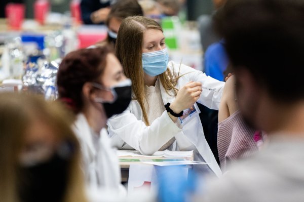 Alyssa Burke, a student in the Physician Assistant Studies program, helps administer the Pfizer vaccine.