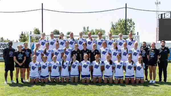 Women's soccer team poses for team photo.