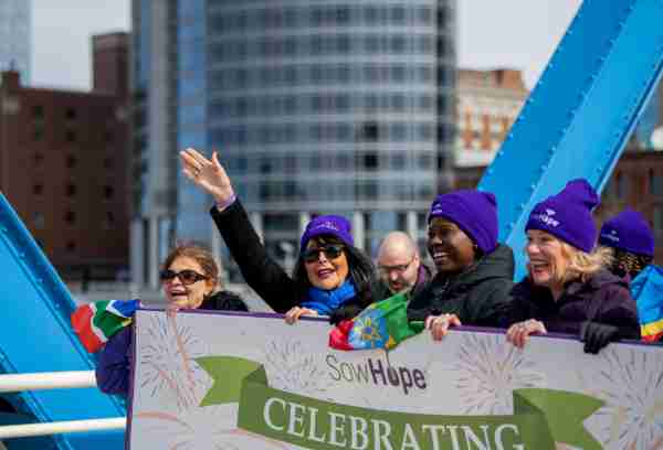 President Philomena V. Mantella waves to the crowd during the International Women's Day march through downtown Grand Rapids.