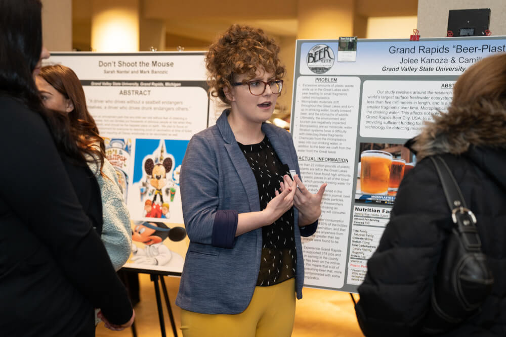 A photo of a female student presenting her research.