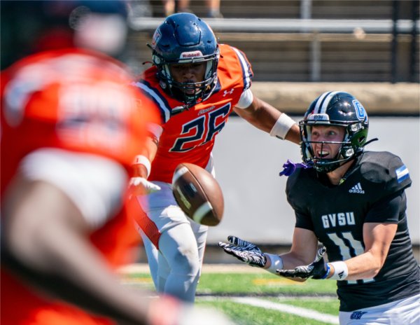 GVSU WR Griffin Shinrock (11) goes after the ball against Lincoln CB Torian Clark-Stewart (26) at Lubbers Stadium on August 30.