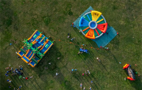 Aerial view of colorful inflatables sitting on a lawn.