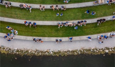  Aerial view of students sitting on the steps by Zumberge pond.