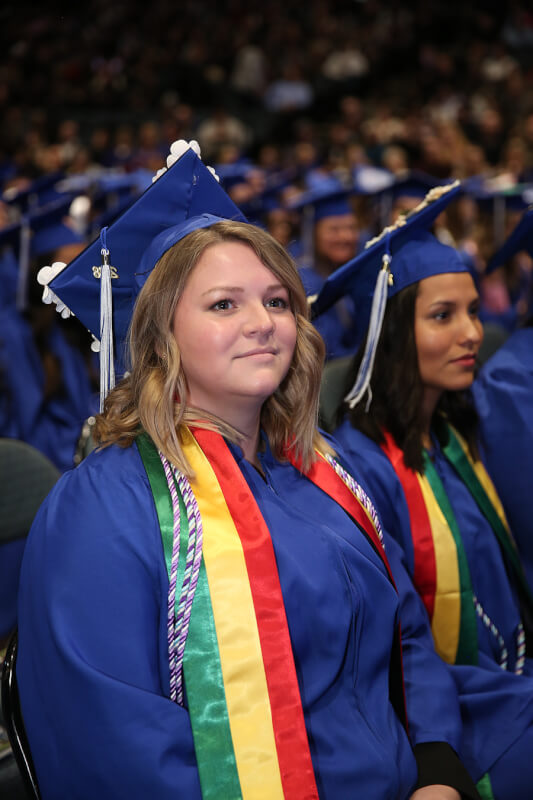 woman seated in audience in academic robe
