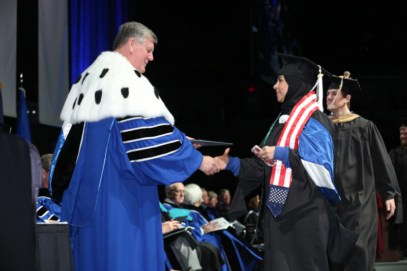 presenting diploma to woman