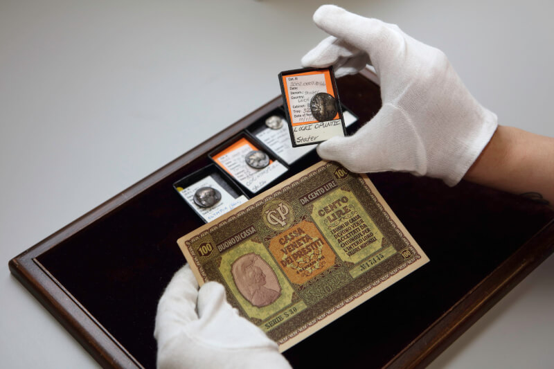 Photo of Hillery York examining ancient monetary objects