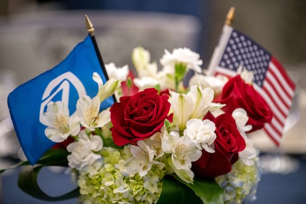 Bouquet of flowers with American flag and GVSU flag.