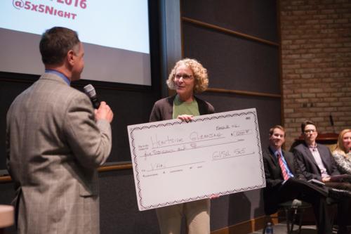 Lisa Sisson, assistant professor of hospitality and tourism management, accepts a check for $5,000