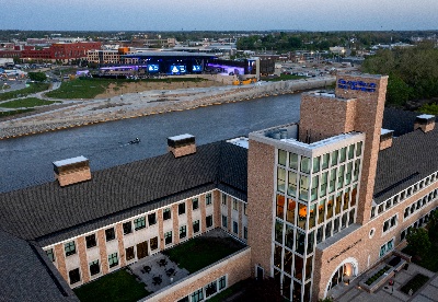 Aerial photo of the L. William Seidman Center at dusk with the Grand River and Acrisure Amphitheater in the background.