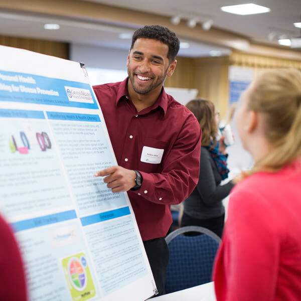 group of students looking at a poster