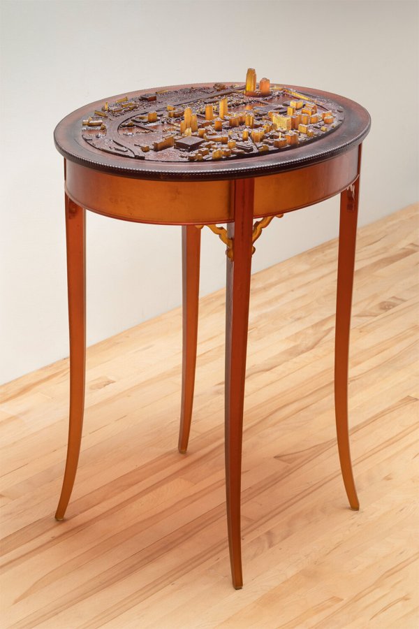 wood table with glasswork of topography of Grand Rapids on top