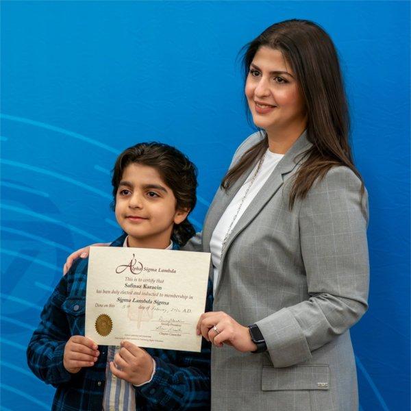 Nursing student Safinaz Karaein poses for a picture with son, Sammy Hasan, 7, during the Alpha Sigma Lambda Honor Society induction ceremony as part of the Sigma Lambda Sigma