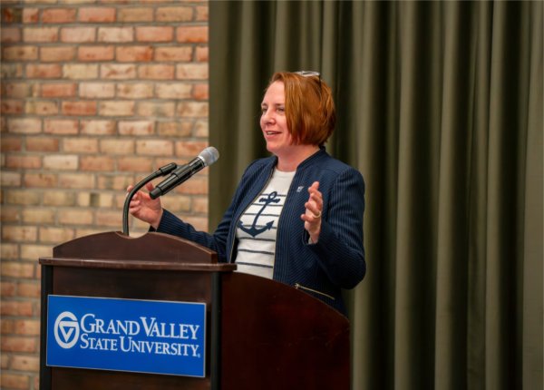 Kara Van Dam gives remarks from a podium