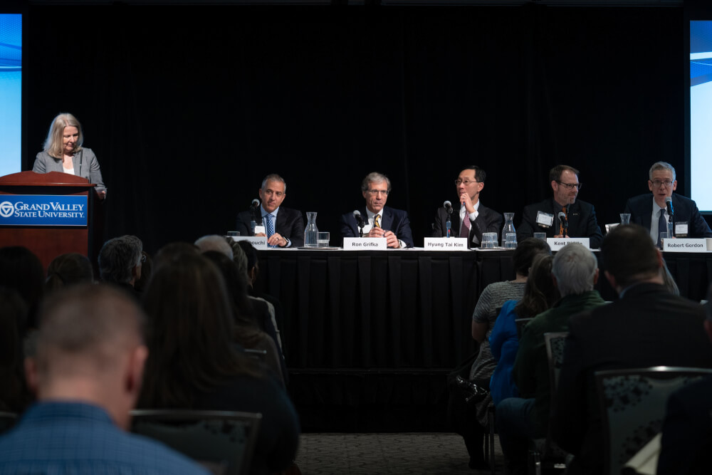woman at podium introducing panelists