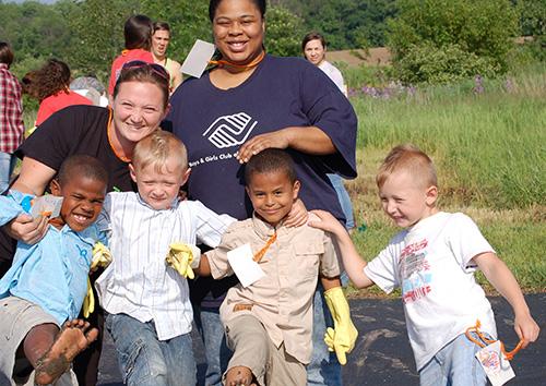 Staff and youth from Heights of Hope celebrate after planting pumpkin seeds at the Meijer Campus in Holland.
