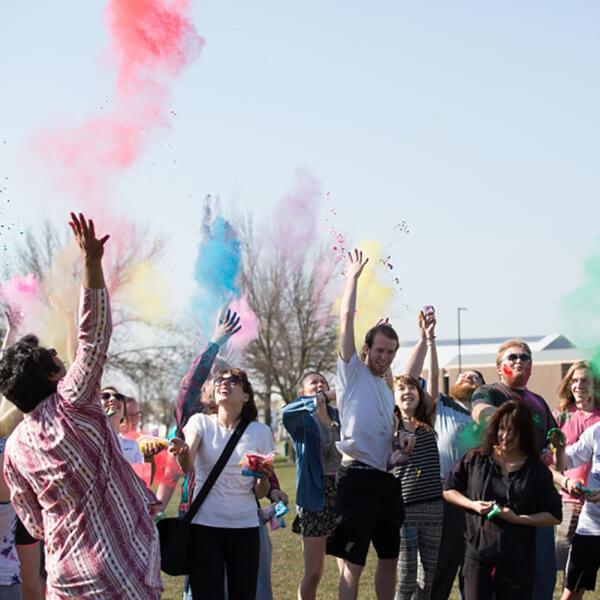 people throwing colored powder