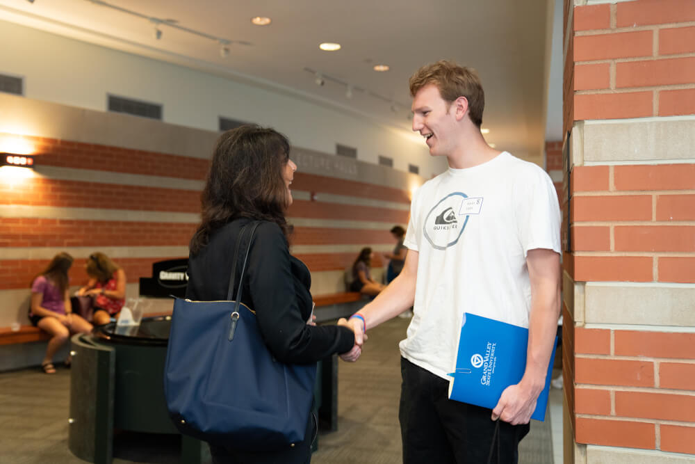 President Mantella greets students and parents at orientation on July 15.