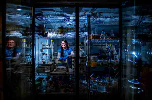 Student poses for a photo inside a refrigerated station at her lab.