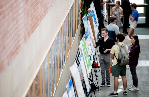 Students discuss their research findings during Student Scholars Day