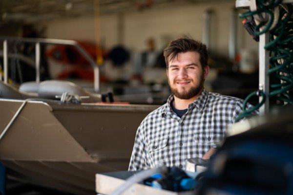 Jacob Yingling poses for a photo in the boathouse at Annis Water Resources Institute in Muskegon