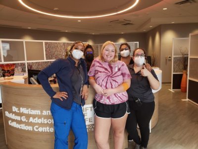 Annabelle Kopcan stands with nurses, in masks, at a clinic after donating stem cells.