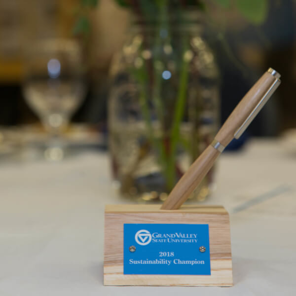 A photo of a 2018 sustainability champion award made out of recycled wood from fallen ash trees on the Allendale Campus.