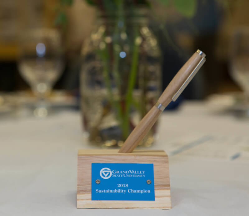 A photo of a 2018 sustainability champion award made out of recycled wood from fallen ash trees on the Allendale Campus.