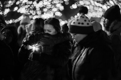 Two students embrace at the vigil, 