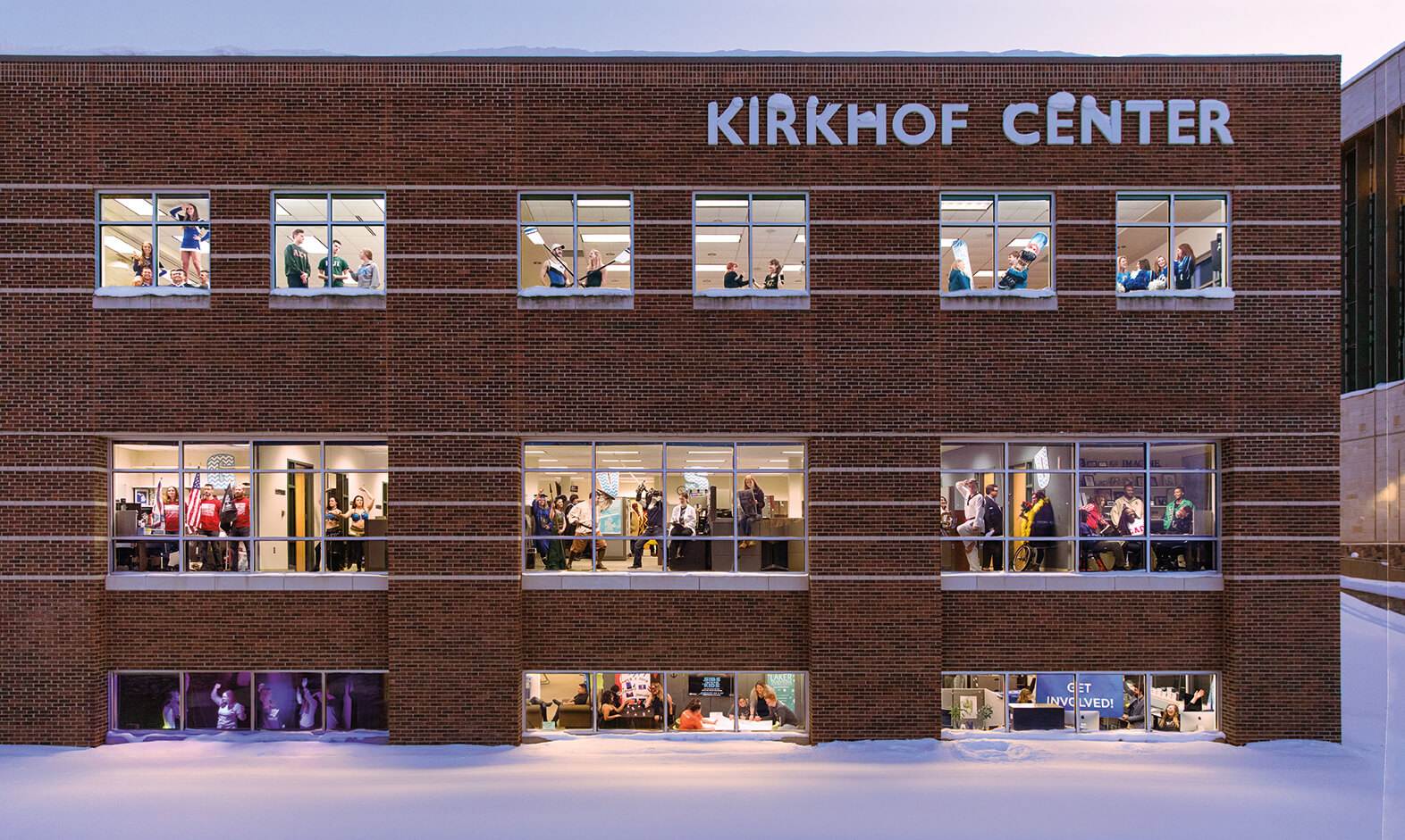 windows of Kirkhof Center lit with students