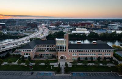 Seidman College of Business building against sunrise in background and highway on left