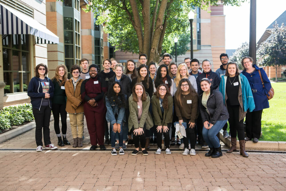 group of people standing to pose for photo in DeVos Center courtyard