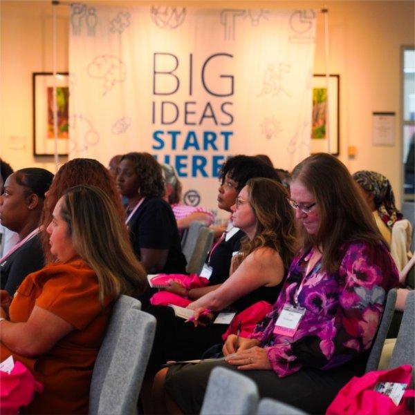 Attendees listen to a panel speaker during the Sparkle & Soar Summit at the Muskegon Innovation Hub.