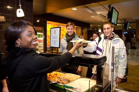 Photo by Mohamed Azuz<br>Alexia Mangala, an international student from the People�s Republic of the Congo, serves a meal during the January International Student Club dinner. This month�s event is set for February 12 at the Connection.