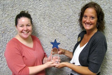 From left, Karrie Erwin and Tammie Luce pose with Campus Dining's Team Excellence Award. 