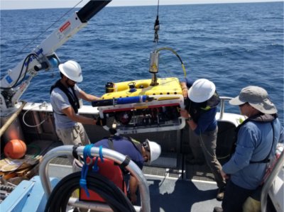 Researchers prepare a remotely operated vehicle to be submerged in a lake