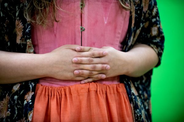 An actor clasps her hands