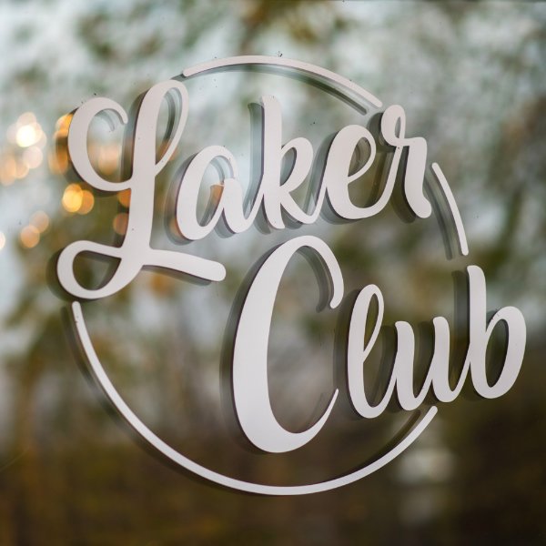 signage of Laker Club in a circle with scripted font