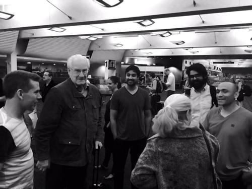 Alain Badiou is pictured at the Gerald R. Ford International Airport with filmmakers, including two Grand Valley faculty members who are producing a documentary about the philosopher.