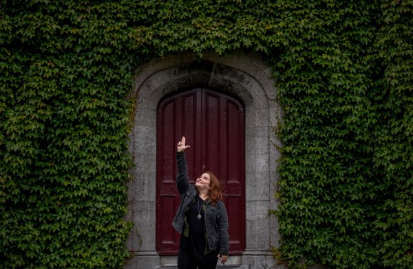 Picture of Kelley Sommers, GVSU senior, making an "Anchor Up" hand sign in Ireland.