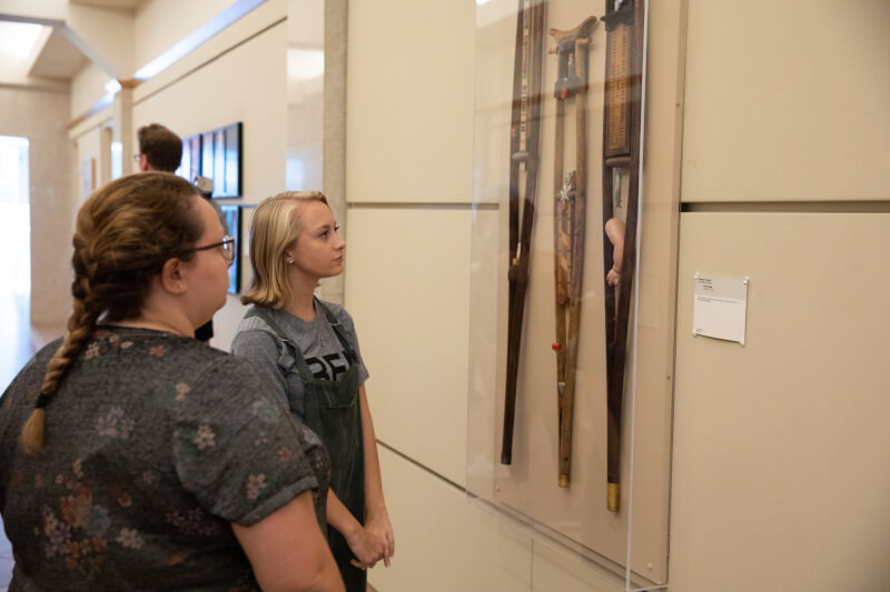 two women look at artwork