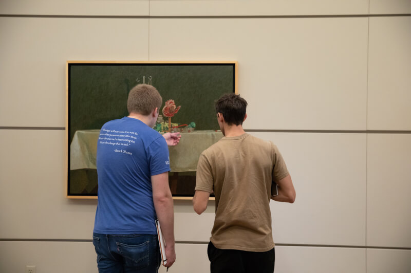 two men look at artwork