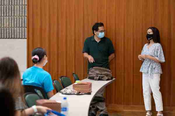 two people in masks talking at Asian Student Orientation