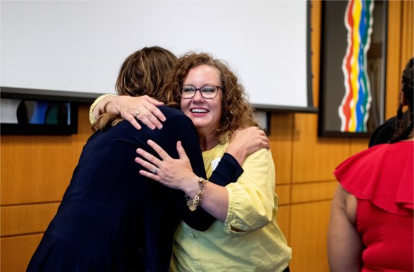 Leslie Bond Strychar, right, hugs fellow entrepreneur  Barbra Katerberg, left, after both being awarded cash prizes during the Michigan Veteran Entrepreneur-Lab final pitch event in Seidman Center May 13.