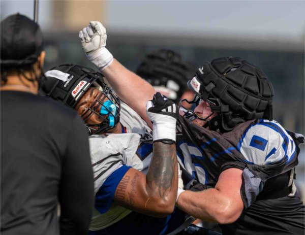  Two college football players collide during practice. 