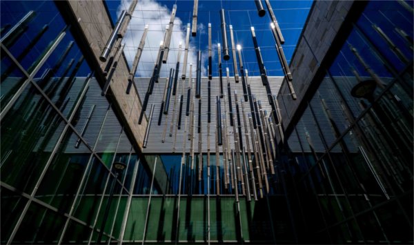  An architectural element of a library is seen against a blue sky. 