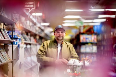 Alumnus Kenny Porter is a comic book writer. Porter was a writing major at Grand Valley. He poses in Vault of Midnight, a local downtown Grand Rapids comic book shop, where his books are sold.
