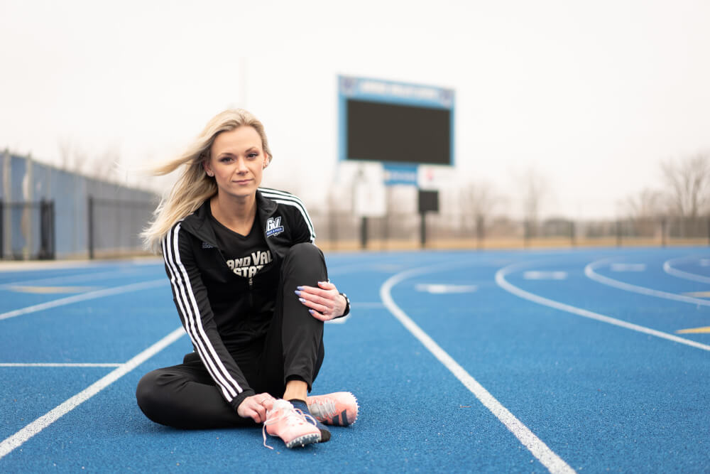 woman in track suit sitting on track