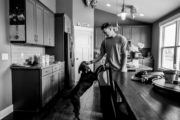 Koda, a black lab, and officer Kelsey Sietsema in the kitchen.
