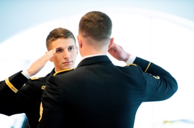 Jackson Wierenga gives his ceremonial first salute to Staff St. Cody McCarthy during his officer commissioning ceremony at the Kirkhof Center on Dec. 9.
