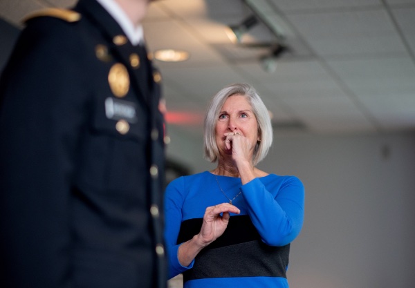 Nancy Wierenga, Lt. Jackson Wierenga's mother, looks on as her son takes part in his officer commissioning ceremony.